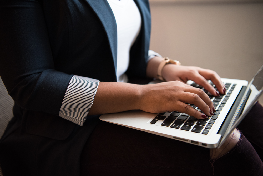 A person typing on a laptop computer