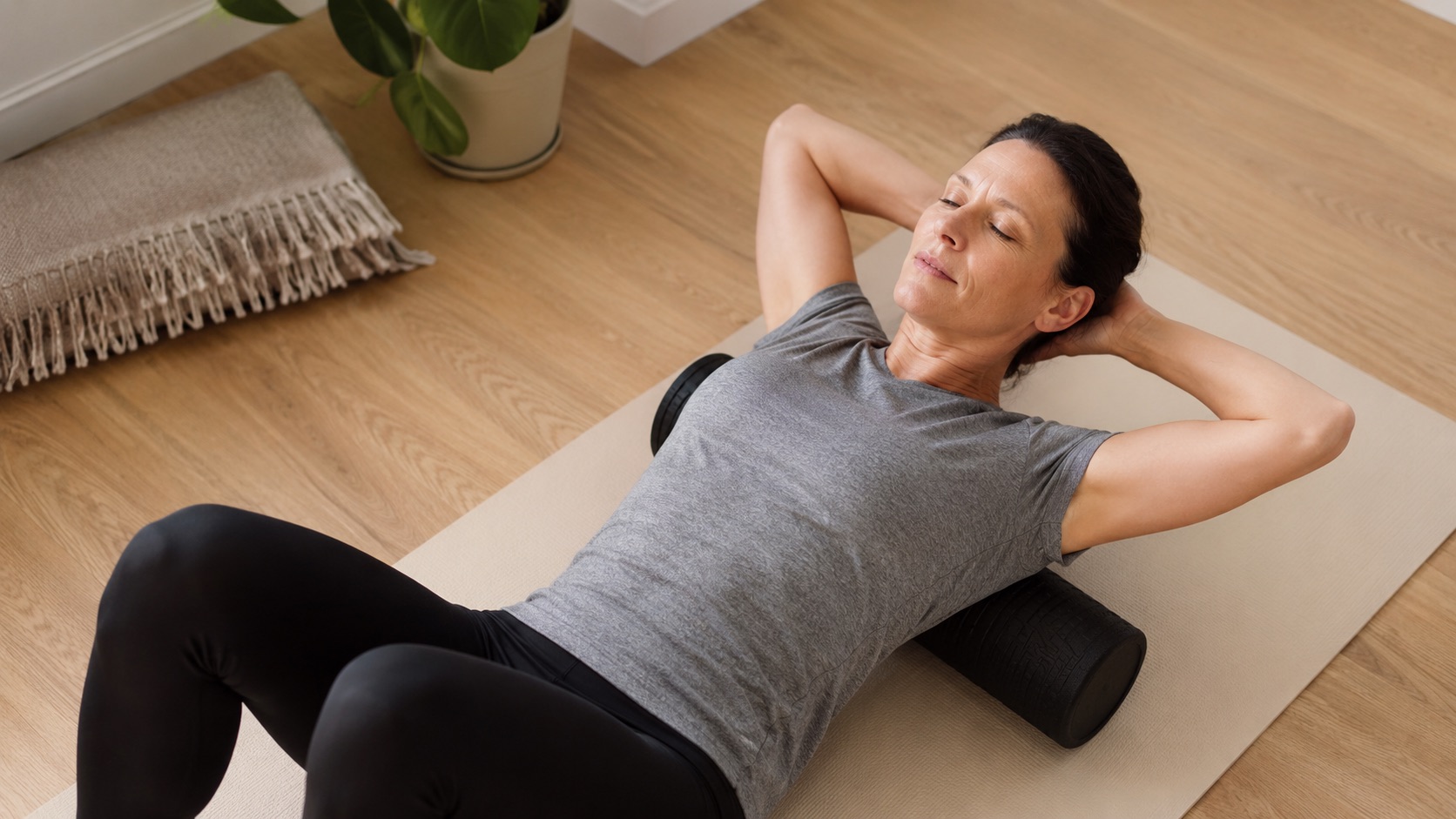 A woman using a foam roller to relieve her bak