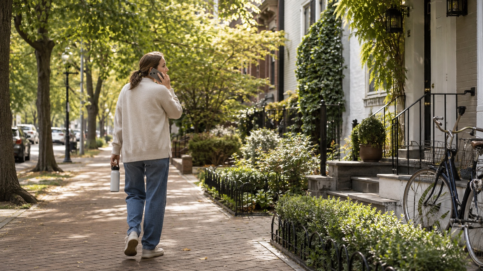A woman walking through a green street