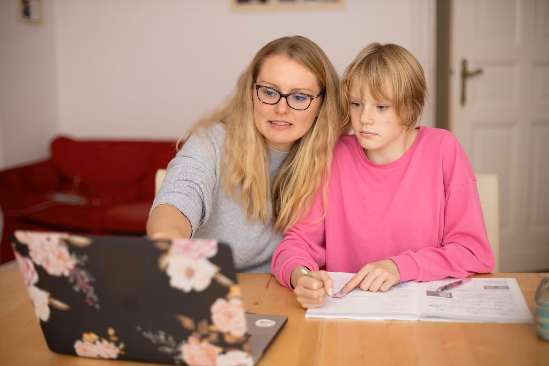 Tutor helping young girl solve problem
