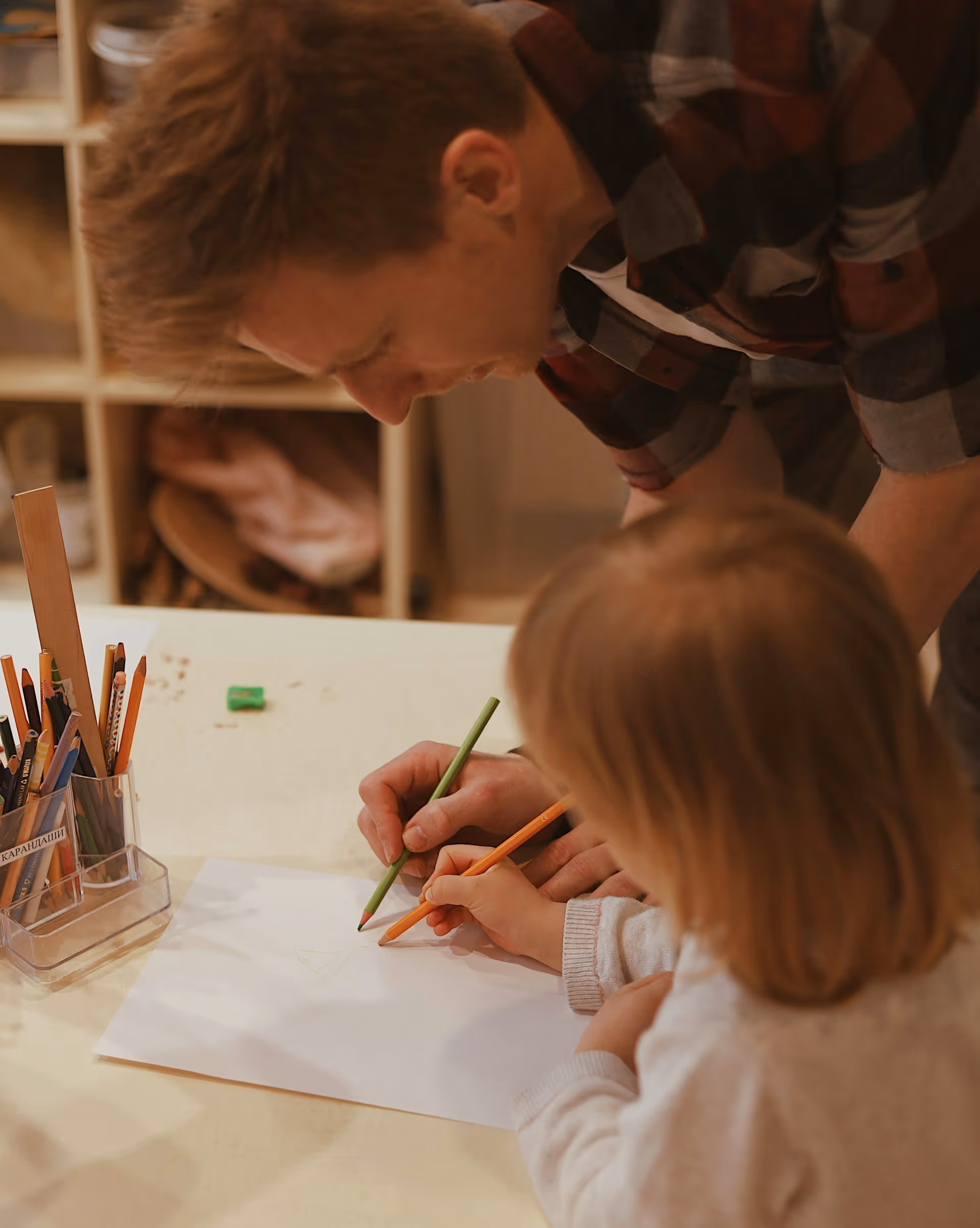 Tutor helping a young student write