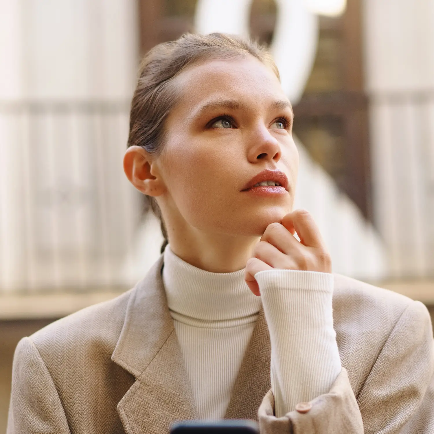A young woman looking into the distance.
