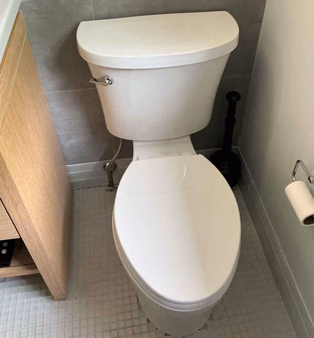 Modern toilet installation with sleek design and water-efficient flush system, professionally fitted by Minuteman Plumbing for residential bathroom upgrade.