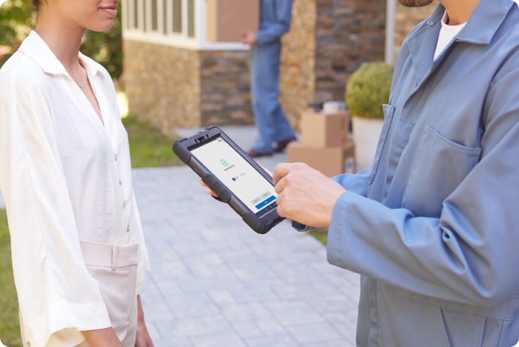 Small business owner ringing up a sale outdoors