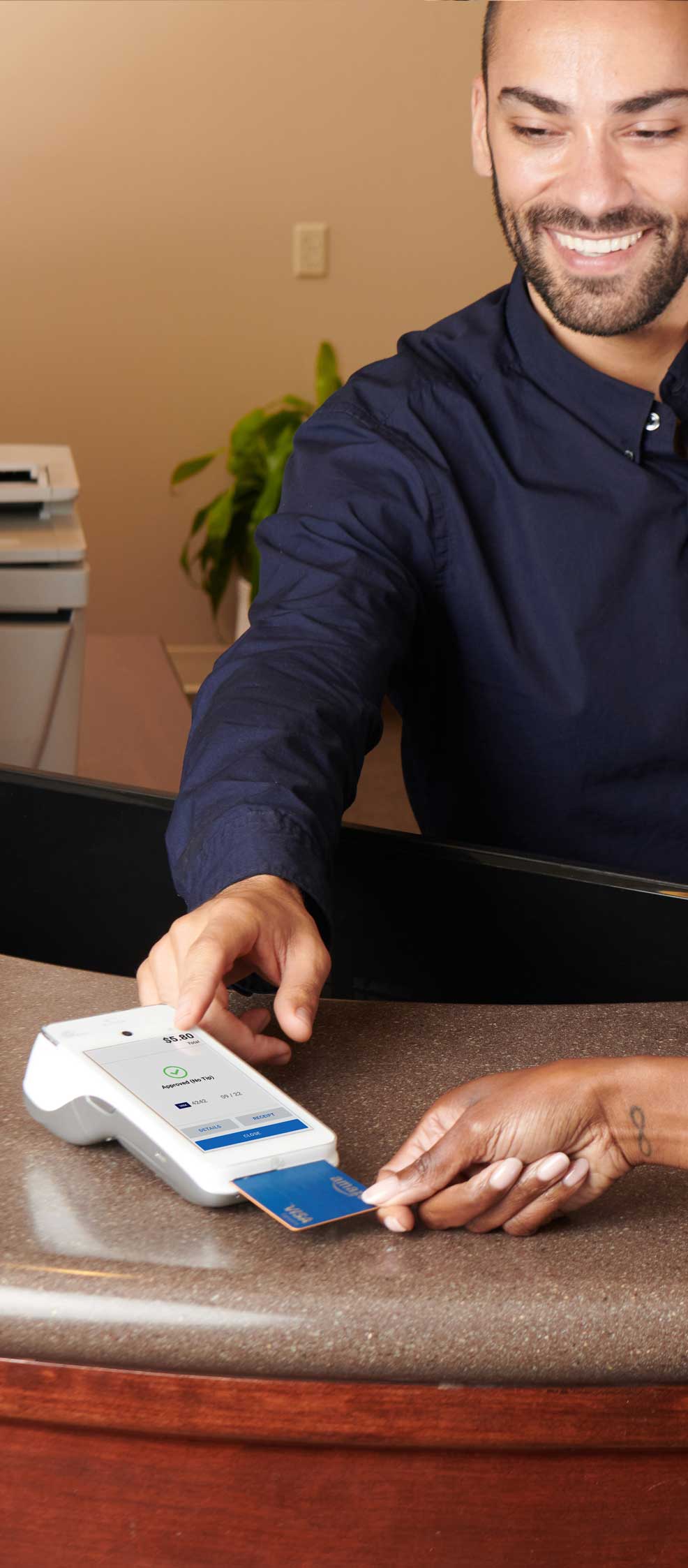 Photo of customer using SwipeSimple Terminal on a counter