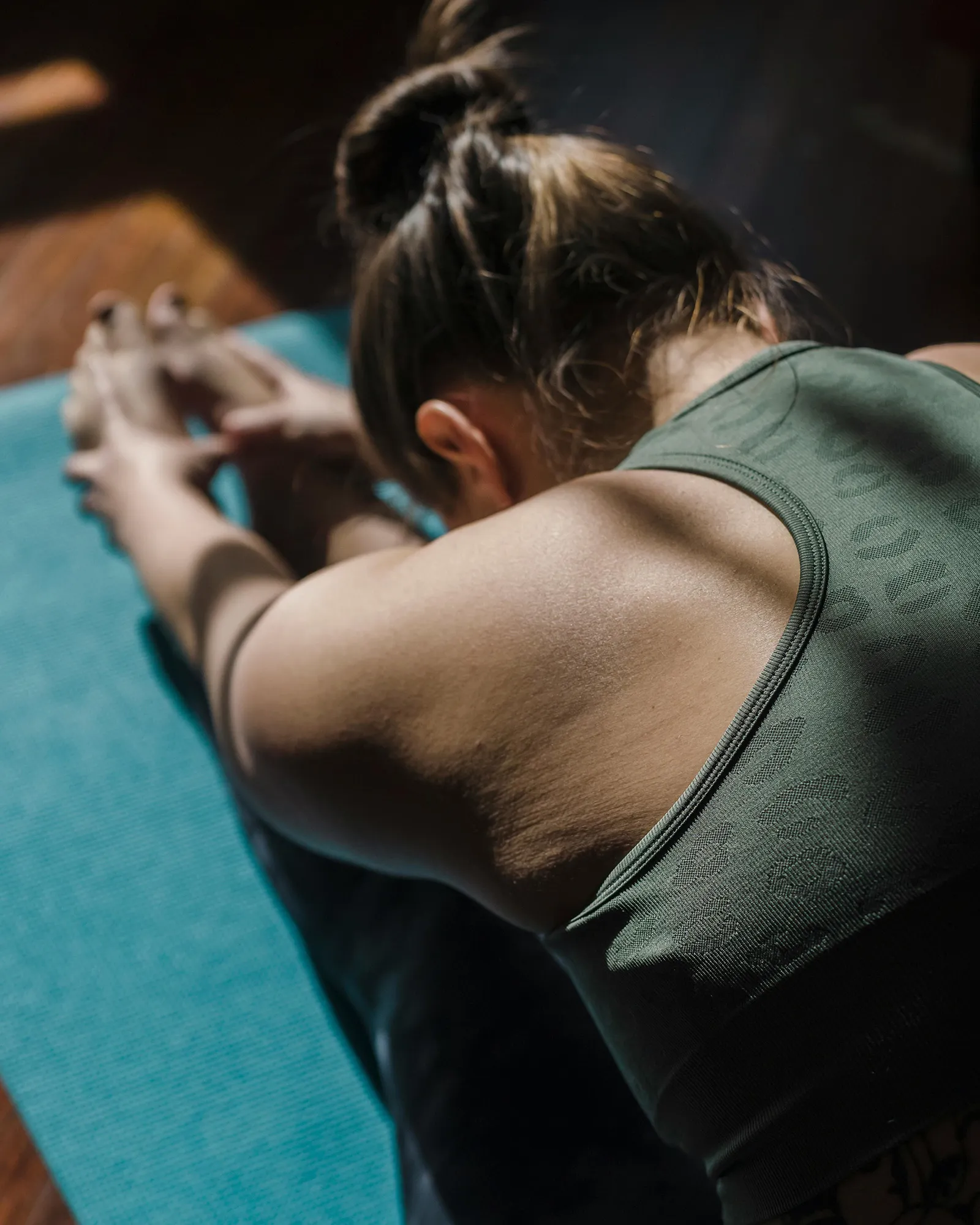 A young female stretching on an exercise mat.
