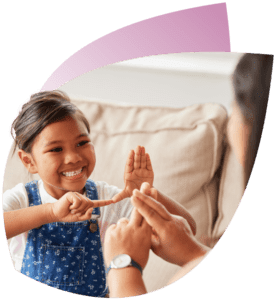 A Support Worker & a child Participant using sign language represents diversity of CareMaster NDIS Software Licences.