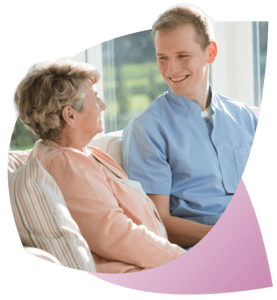 A Support Worker, having a conversation with an NDIS Participant, refers to CareMaster’s Document Control for guidance.