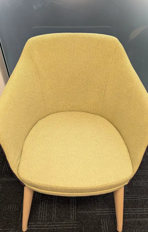 Yellow fabric chair shown after professional cleaning, fabric looking bright and refreshed.