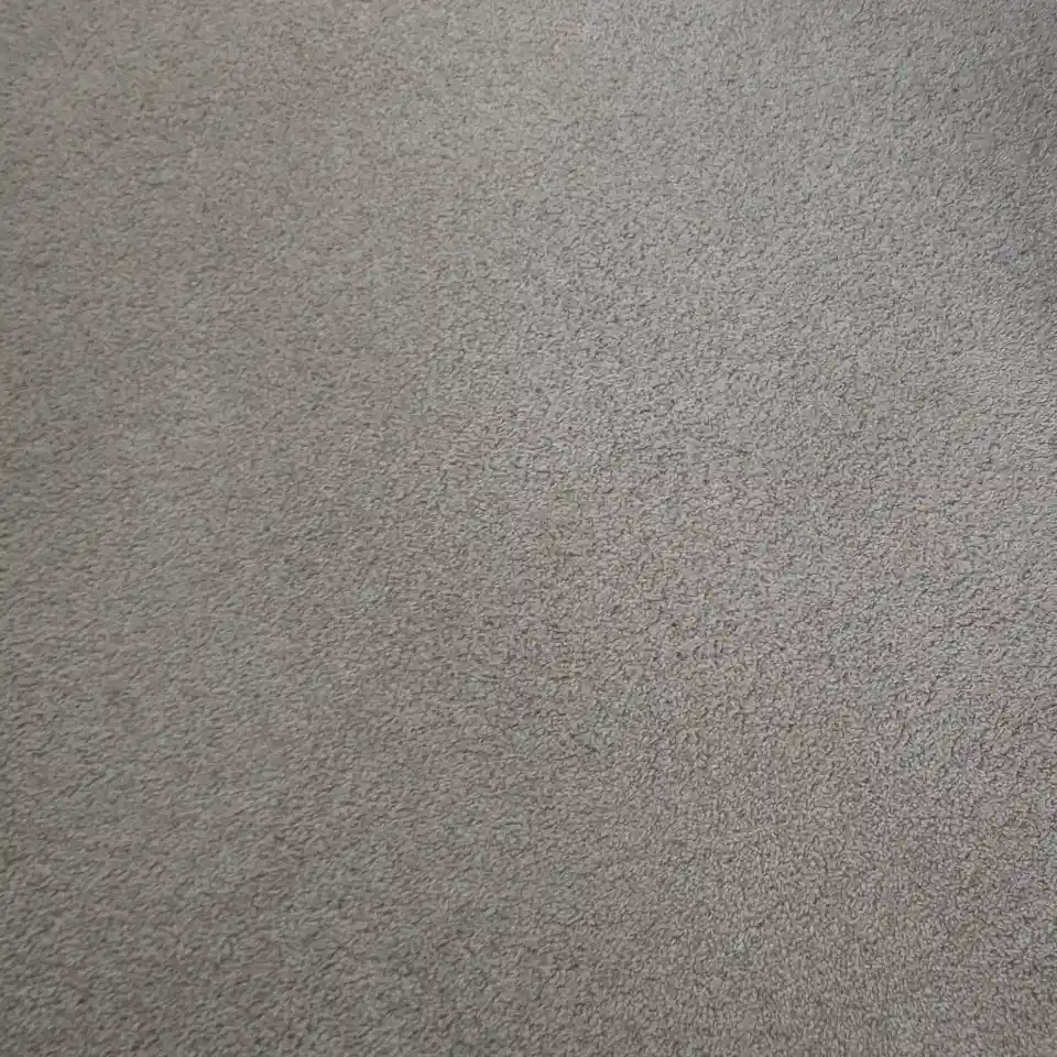 Close-up view of a clean light grey carpet surface.