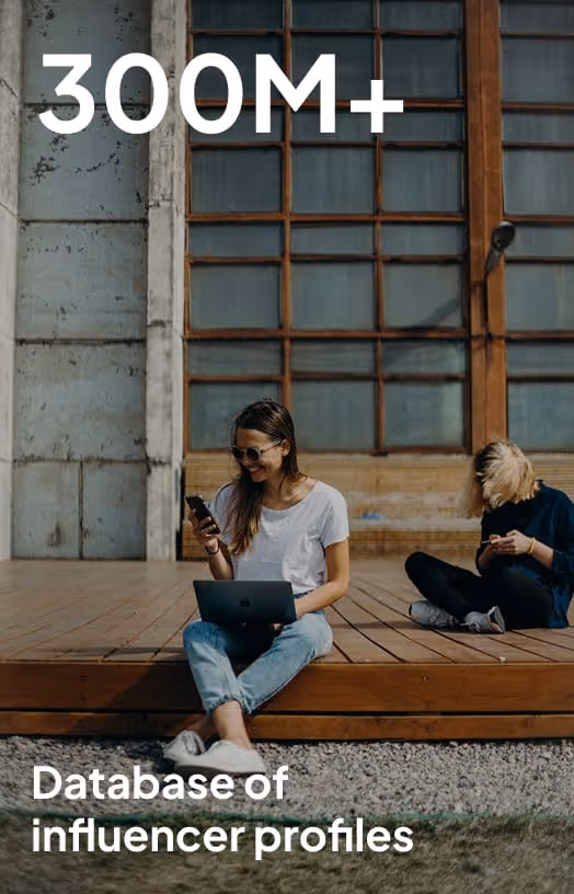 Two young women sitting outside on wooden deck using laptops and smartphones with text '300M+ Database of influencer profiles'.