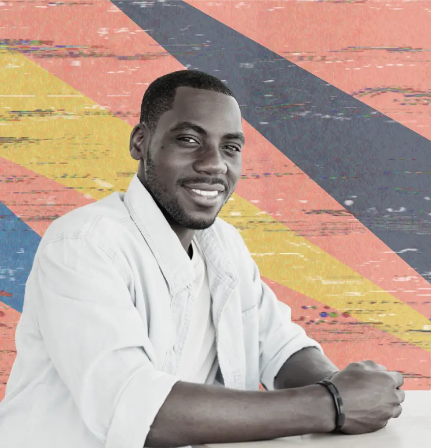 Young man looking into camera seated. Abstract colorful background with diagonal paint strokes in blue, orange, and yellow.