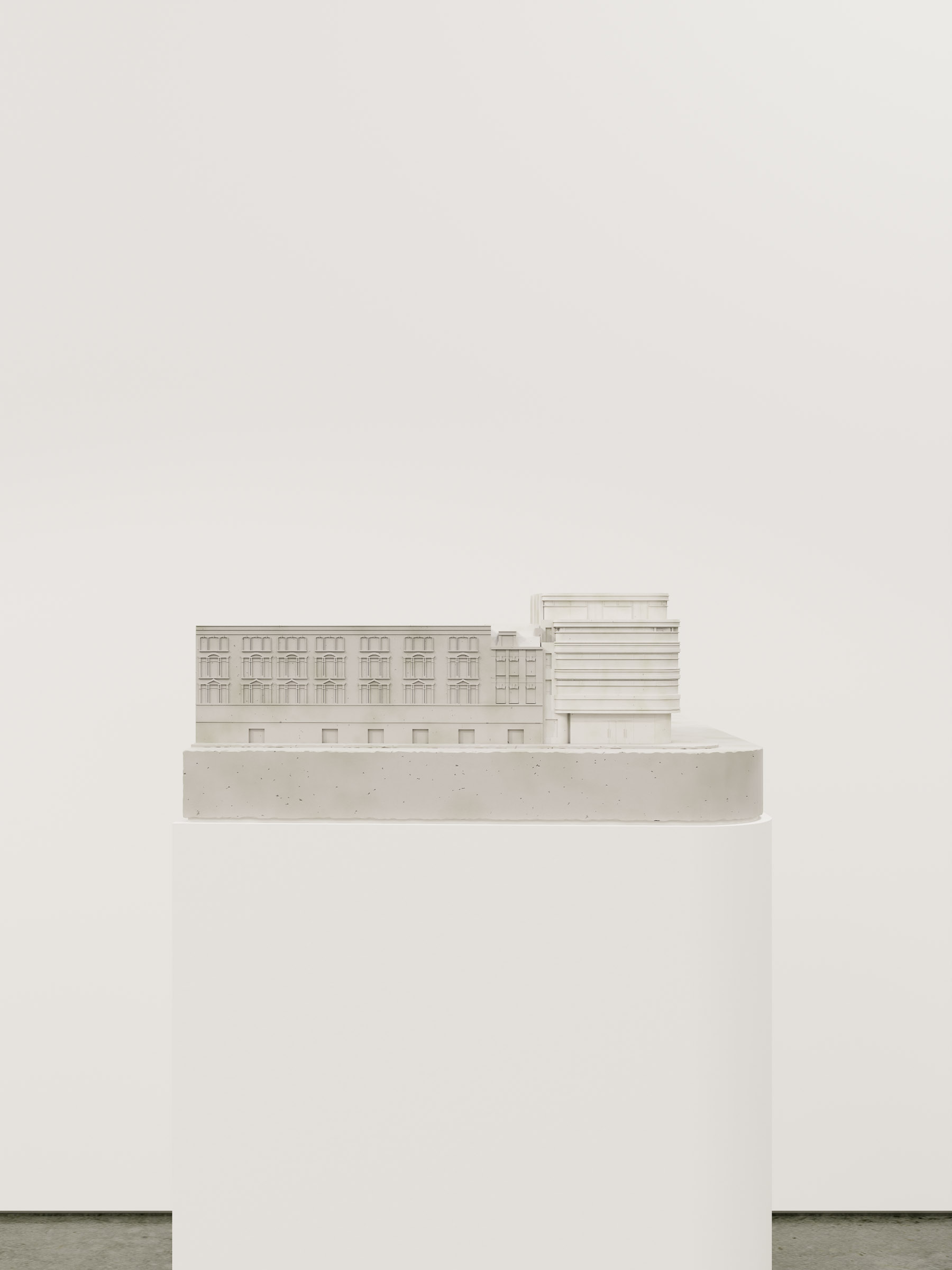 Frontal elevation of the physical model displaying the full block composition and corner articulation.