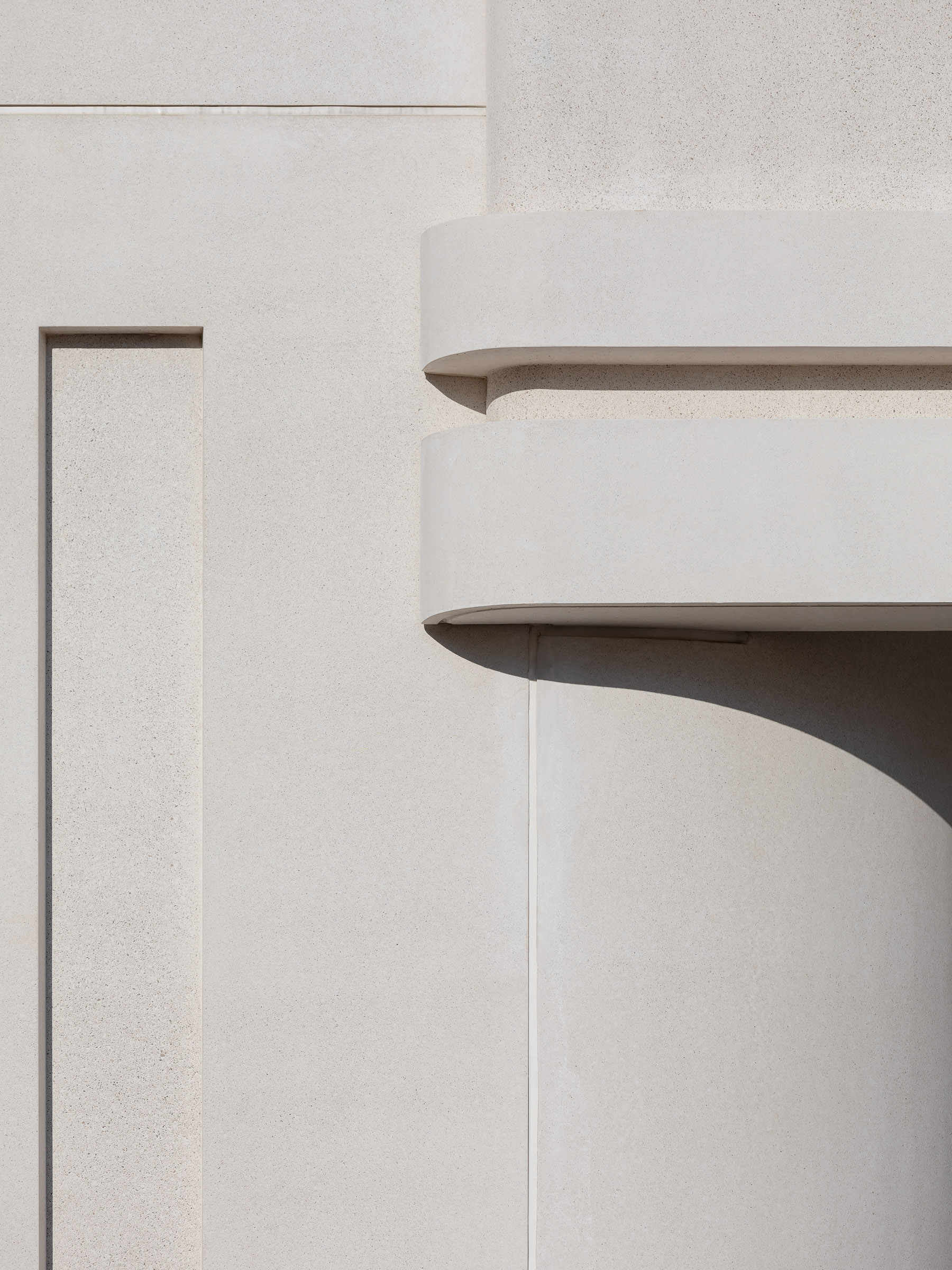 Final assembly detail showing the integration of curved facade geometry with recessed vertical and horizontal joints.