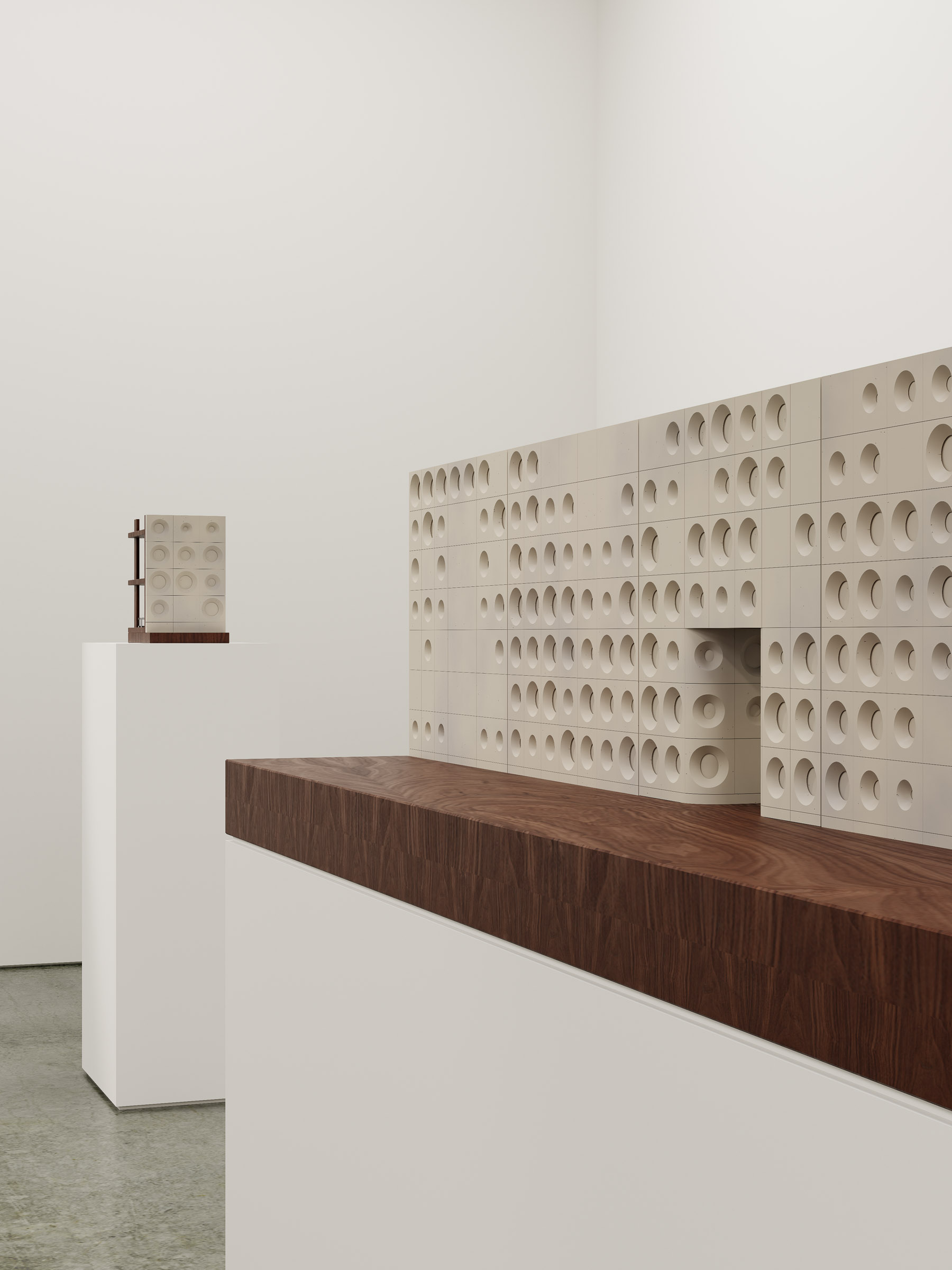 Exhibition view of two façade study models showing prototype panels and sectional construction logic on display plinths.