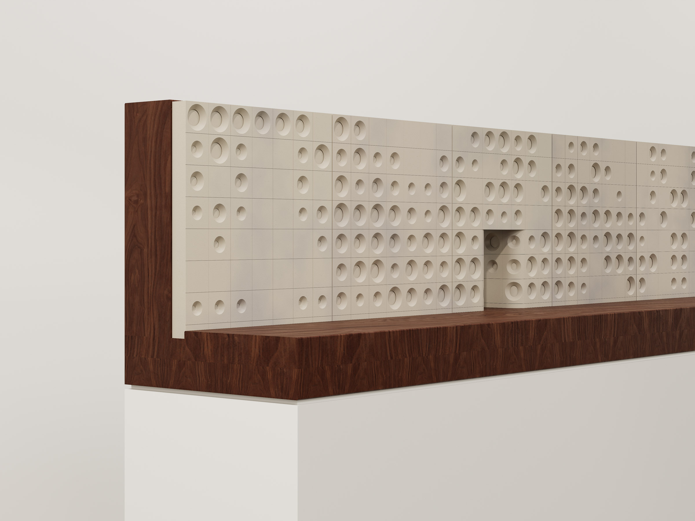 Study model showing circular recess pattern in white panels mounted on a timber base.