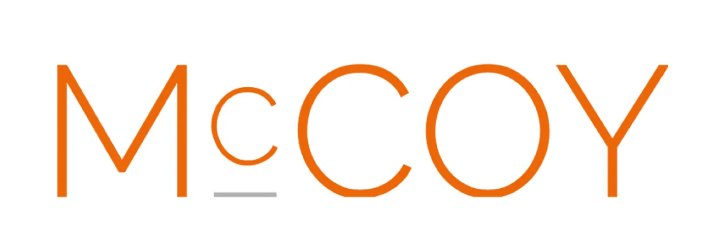 McCoy Logo with orange text on white background