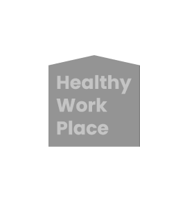 Gray badge or shield icon with white text reading "Healthy Work Place"