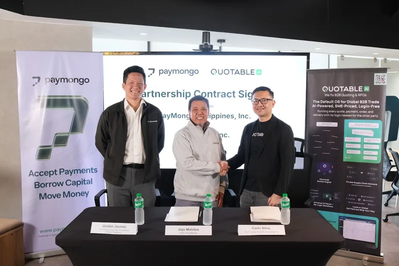 Three business professionals shake hands at partnership contract signing event between Paymongo and Quotable.