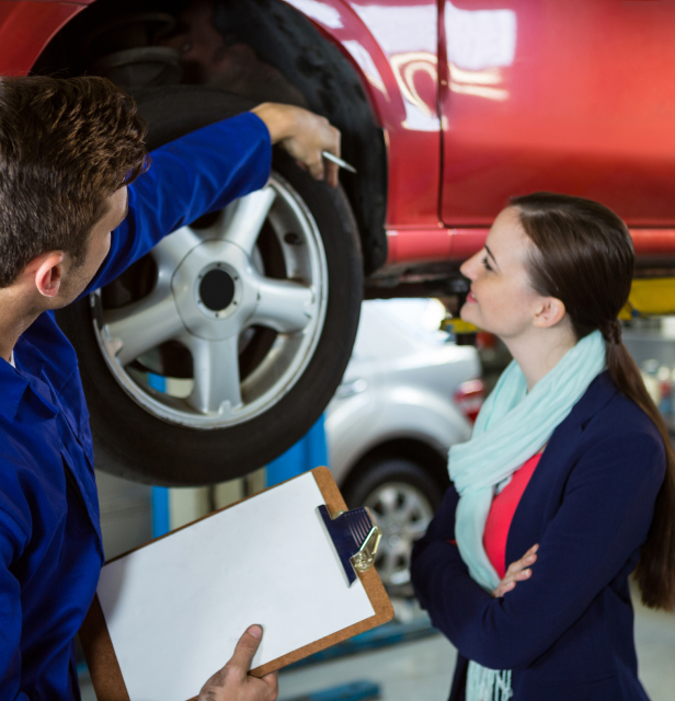 Cheerful employees changing a tire