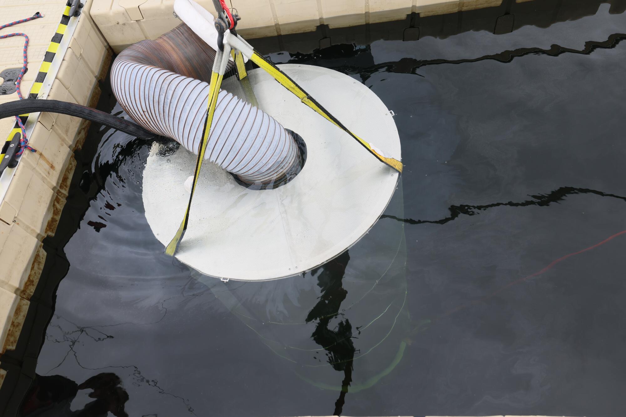 A prototype of OceanWell's desalination pod is lowered into Las Virgenes Reservoir near Westlake Village.