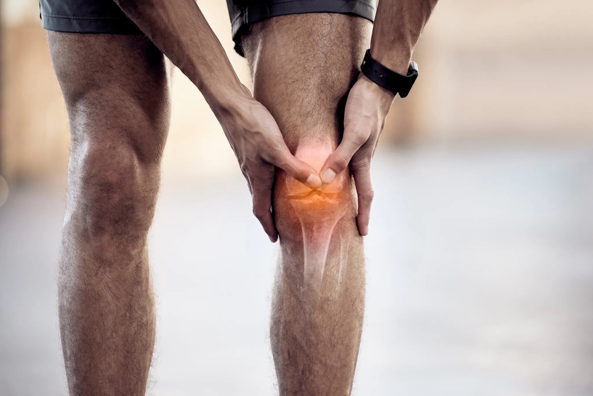Man holding knee in pain