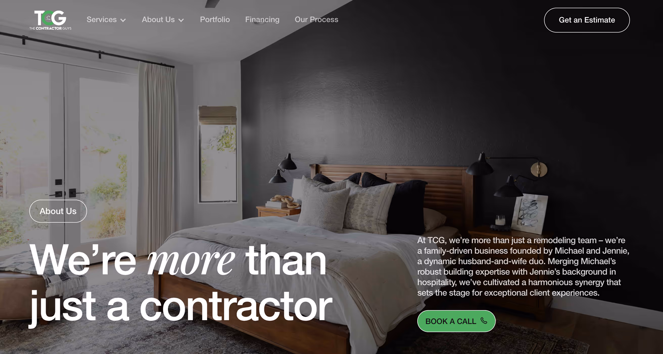 Modern bedroom with wooden bed, neutral bedding, black accent wall, and natural light from large windows.