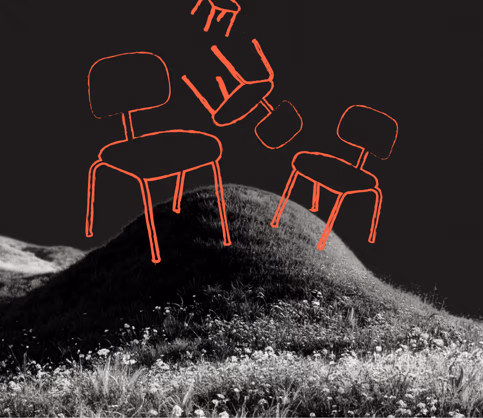Black and white photo of a grassy hill with red outlines of three chairs floating above it against a dark sky.