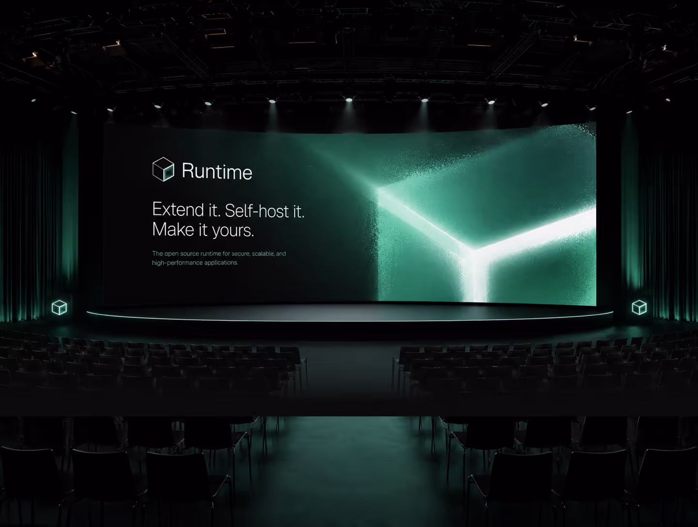 Dark auditorium with empty seats faces a large screen showing a glowing green cube and runtime software text.