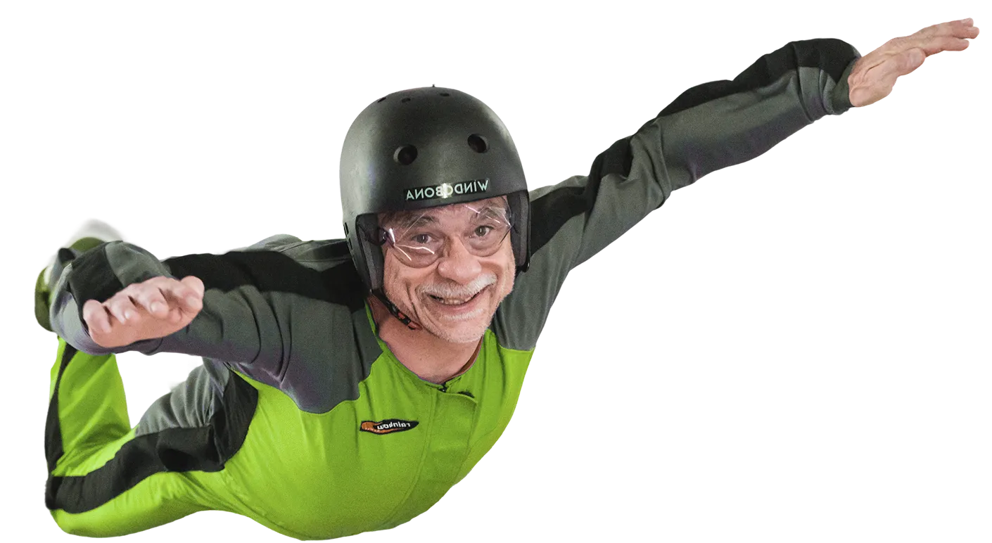 Older man smiling mid-flight