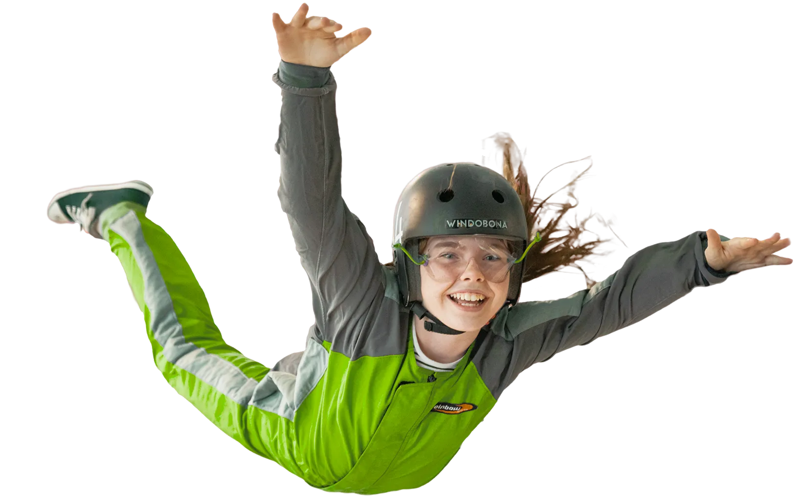 Girl in green flight suit skydiving indoors