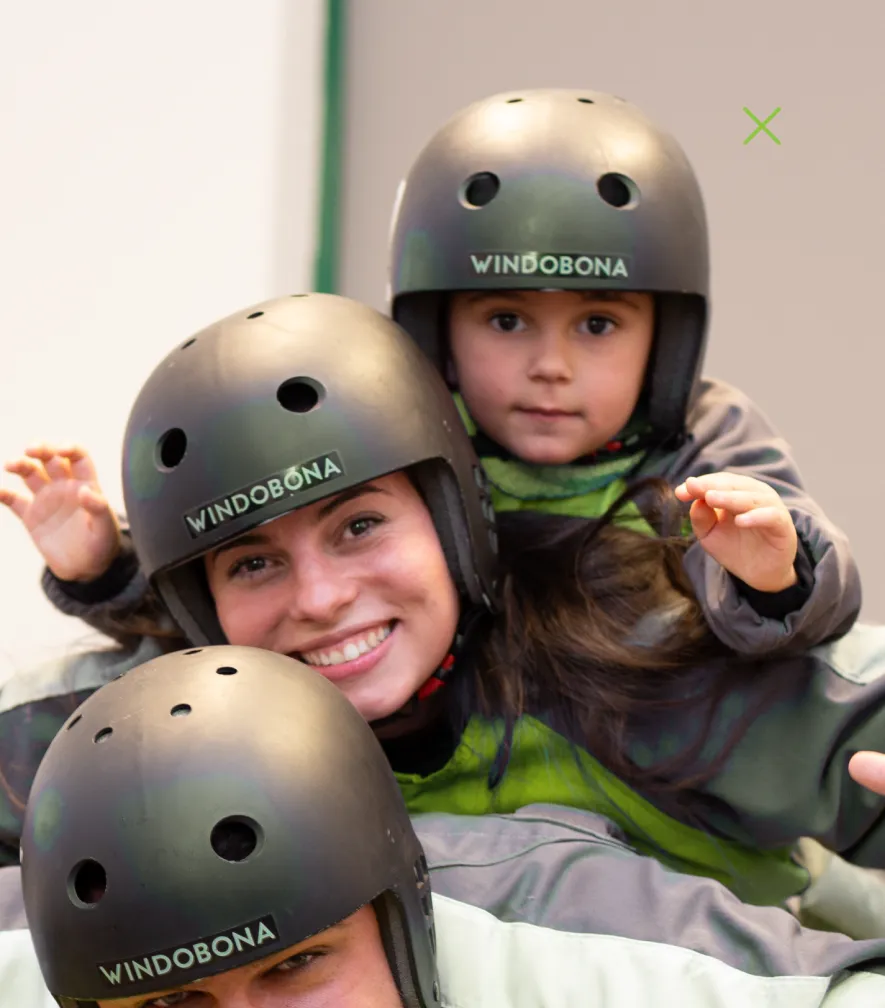 Mother and child in helmets smiling before skydiving