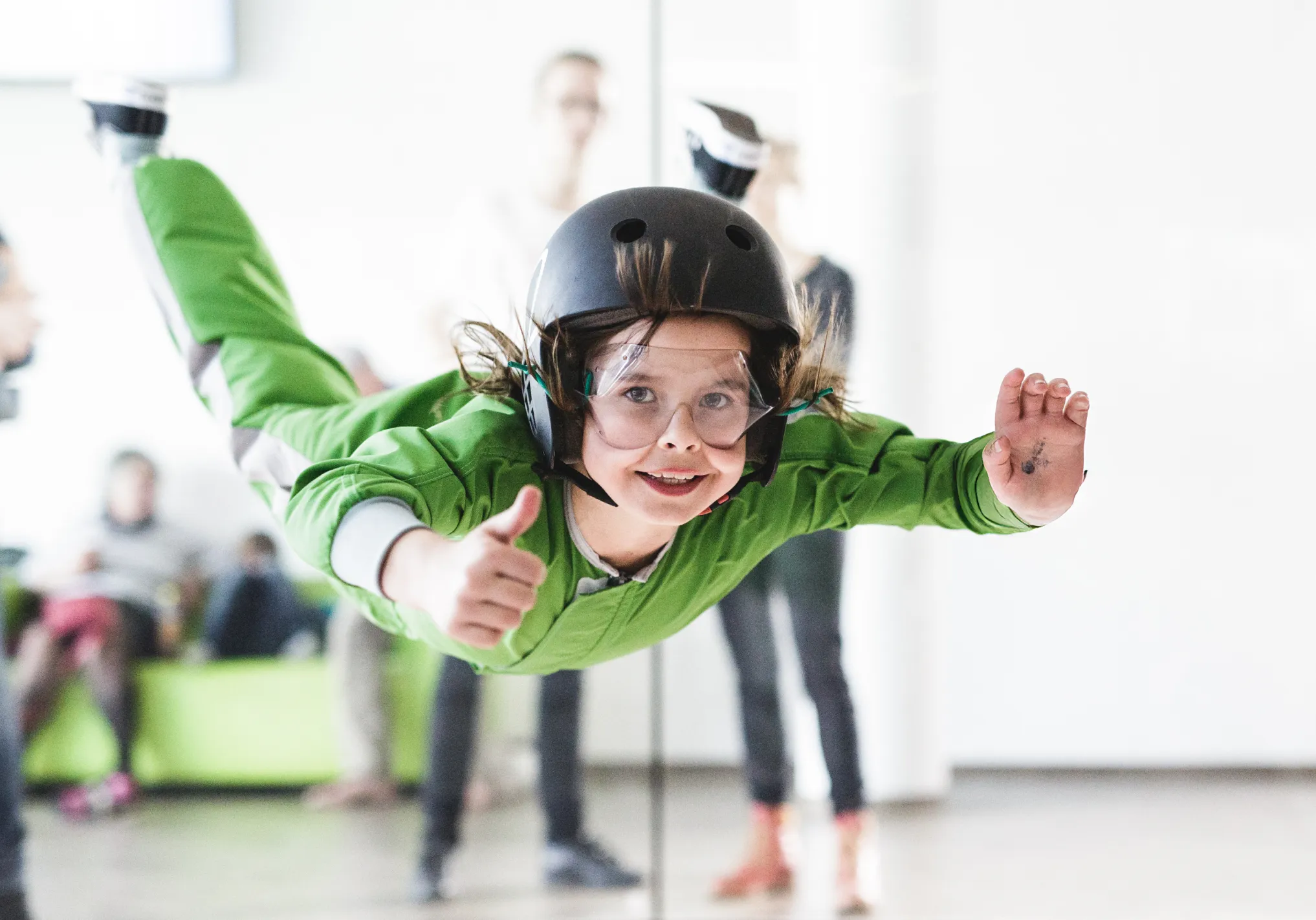 Child flying with thumbs up