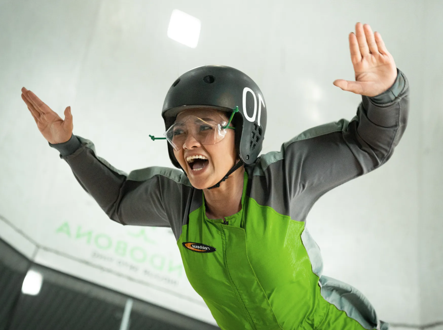Woman smiling mid-air indoor skydive