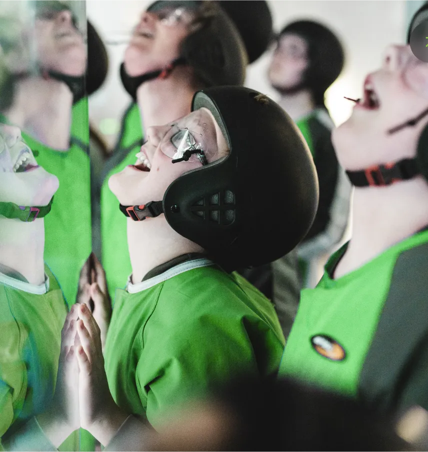 Child laughing in helmet reflection