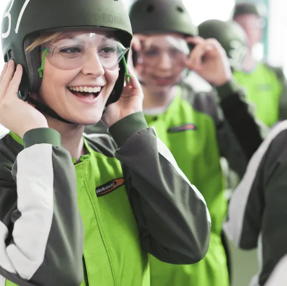 Woman smiling adjusting helmet