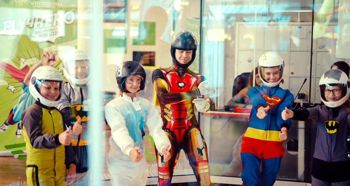 Kids in superhero flight suits