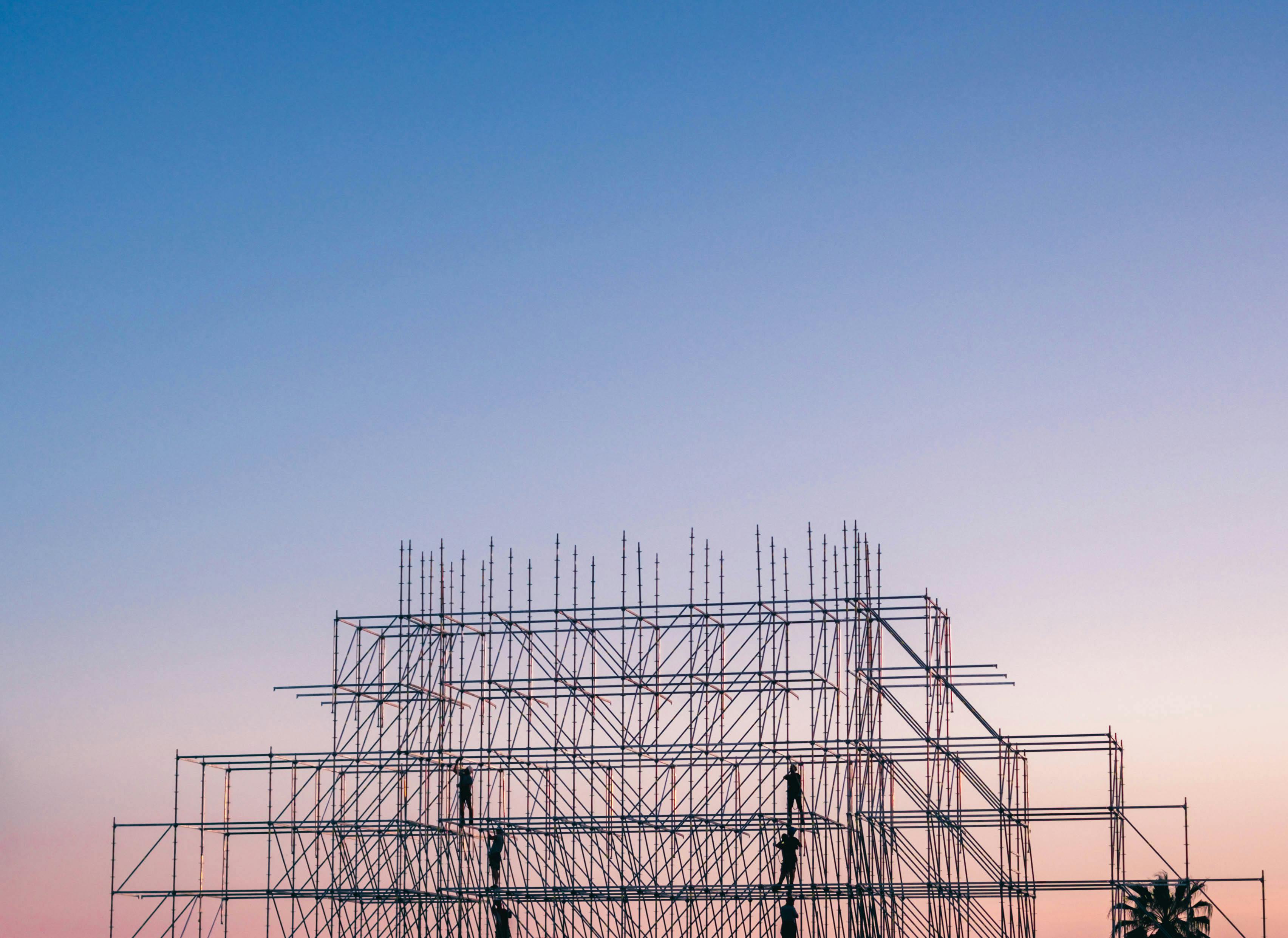 Construction site in front of colourful sky. Photo by Igor Starkov.