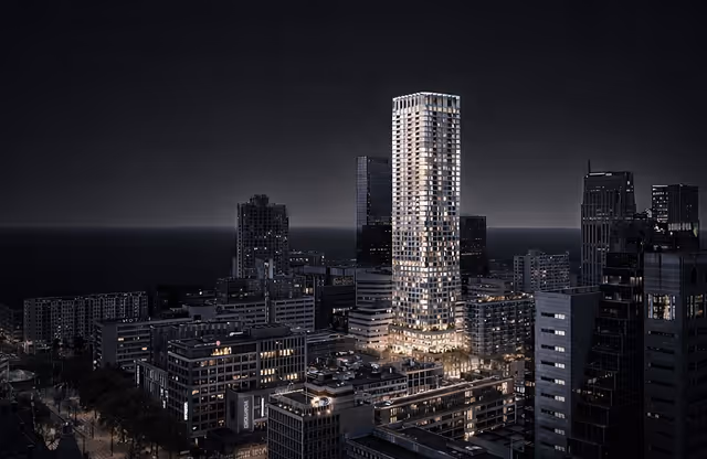 Nighttime cityscape featuring a tall illuminated skyscraper surrounded by shorter buildings.