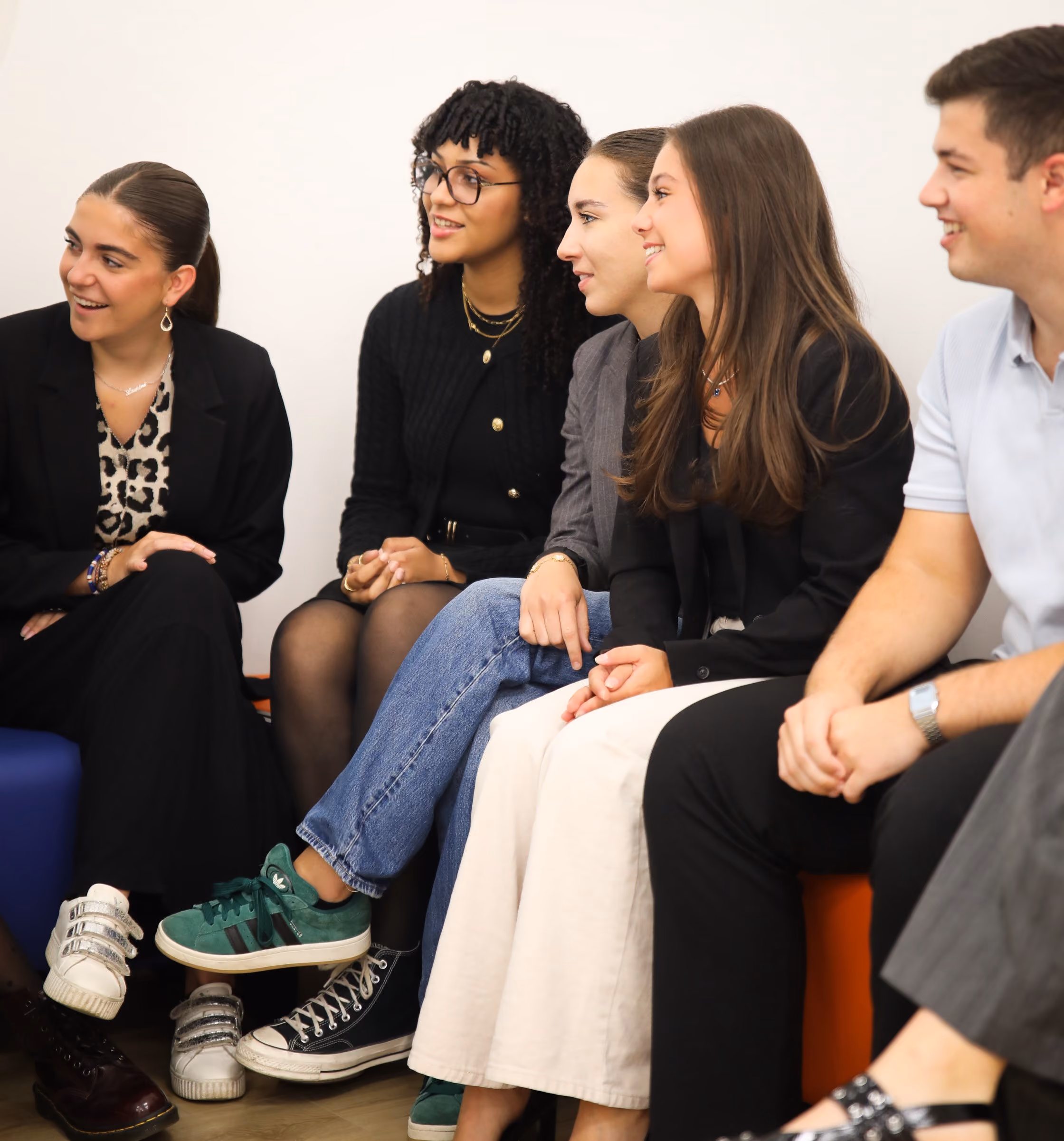 groupe d'étudiants assis sur un banc d'un air joyeux