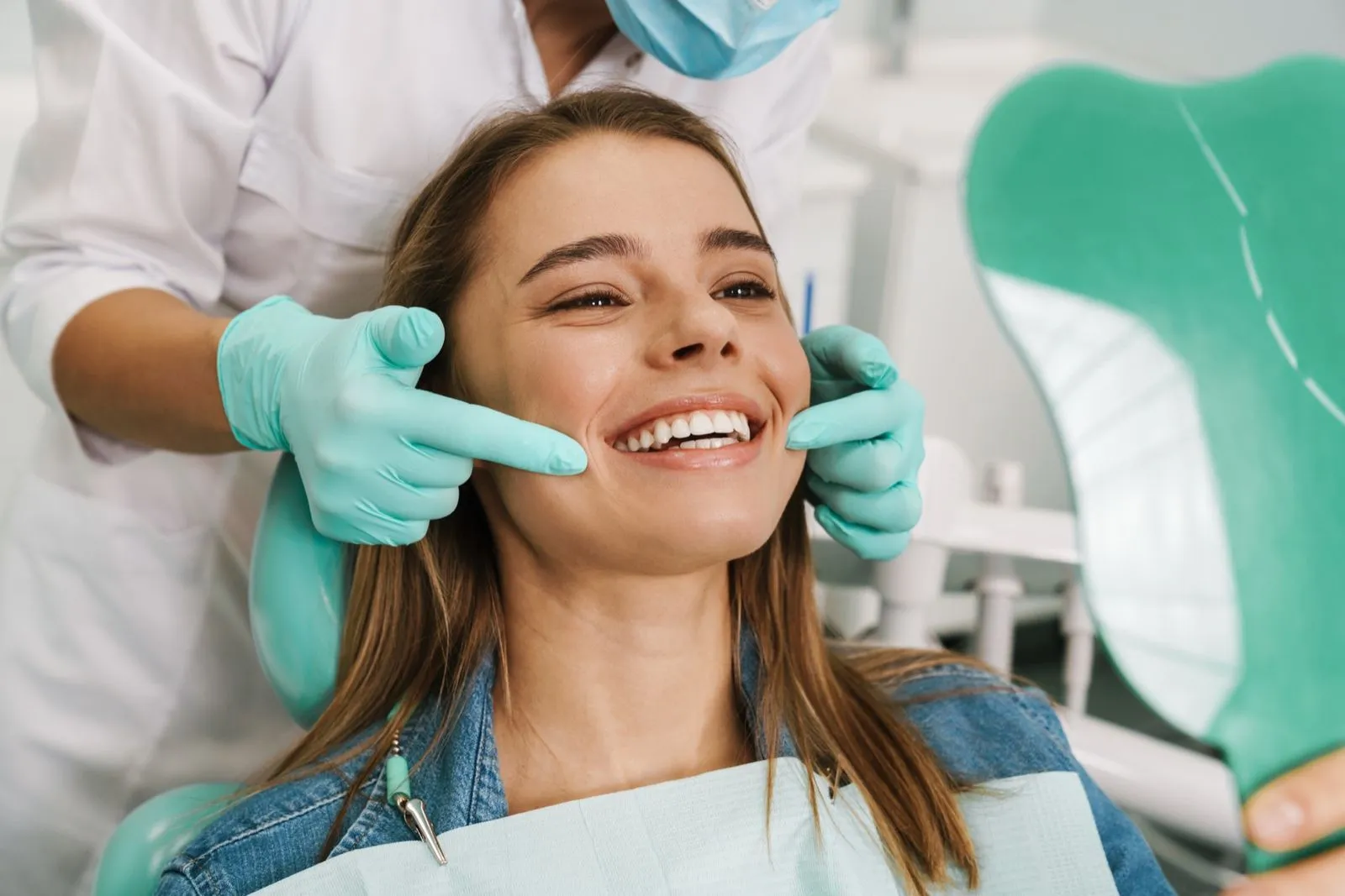 Smiling patient at dental clinic during examination with dentist