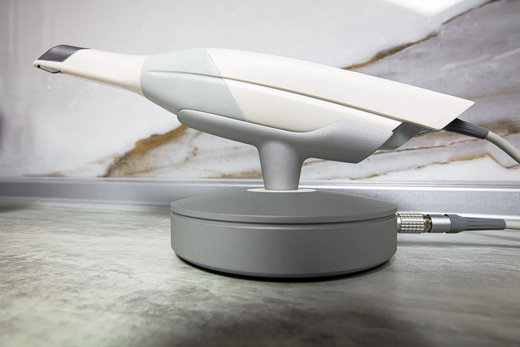 Modern white and gray hair straightener on sleek charging dock