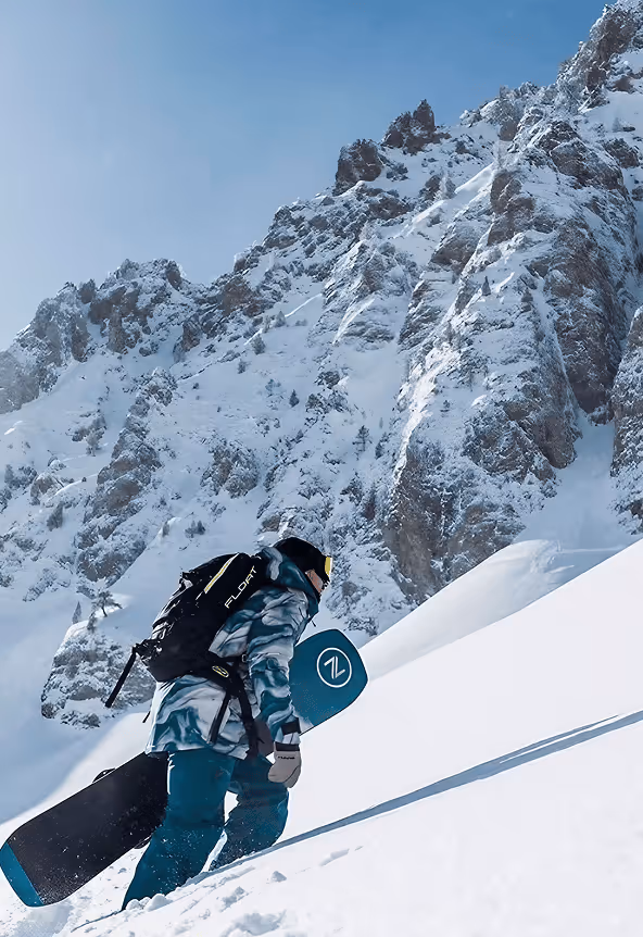 snowboarder head to the top of mountain
