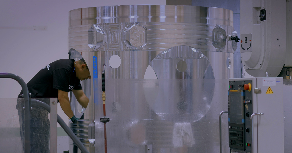 A man works on high tech machinery.
