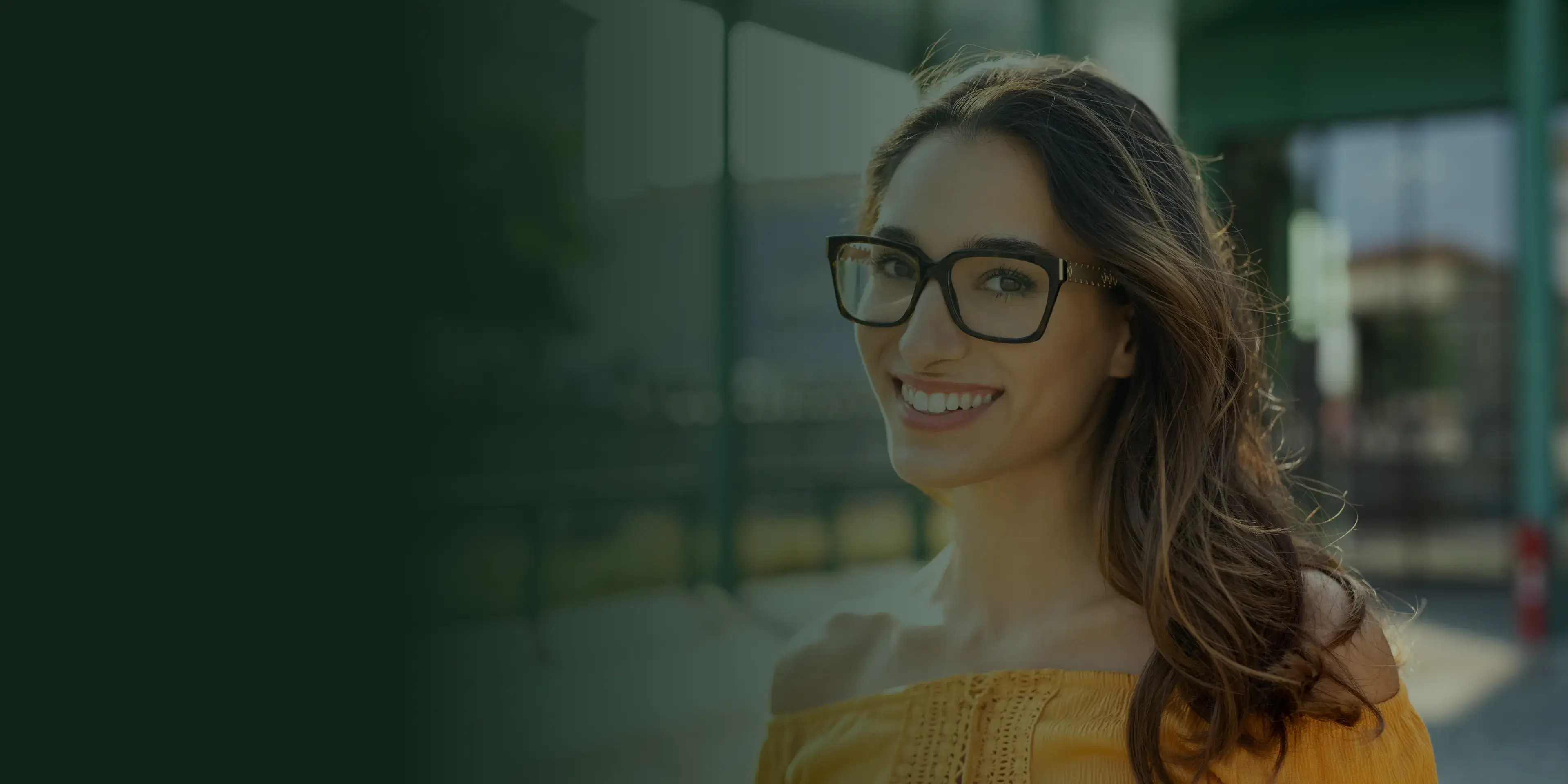 A woman in a white robe sits smiling and talks with a medical professional.