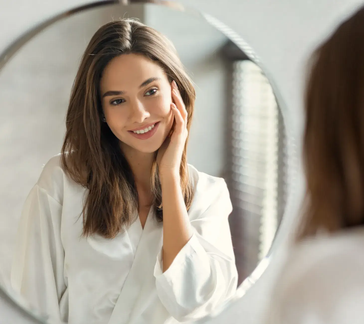 A man in a green shirt smiles and looks towards the camera.