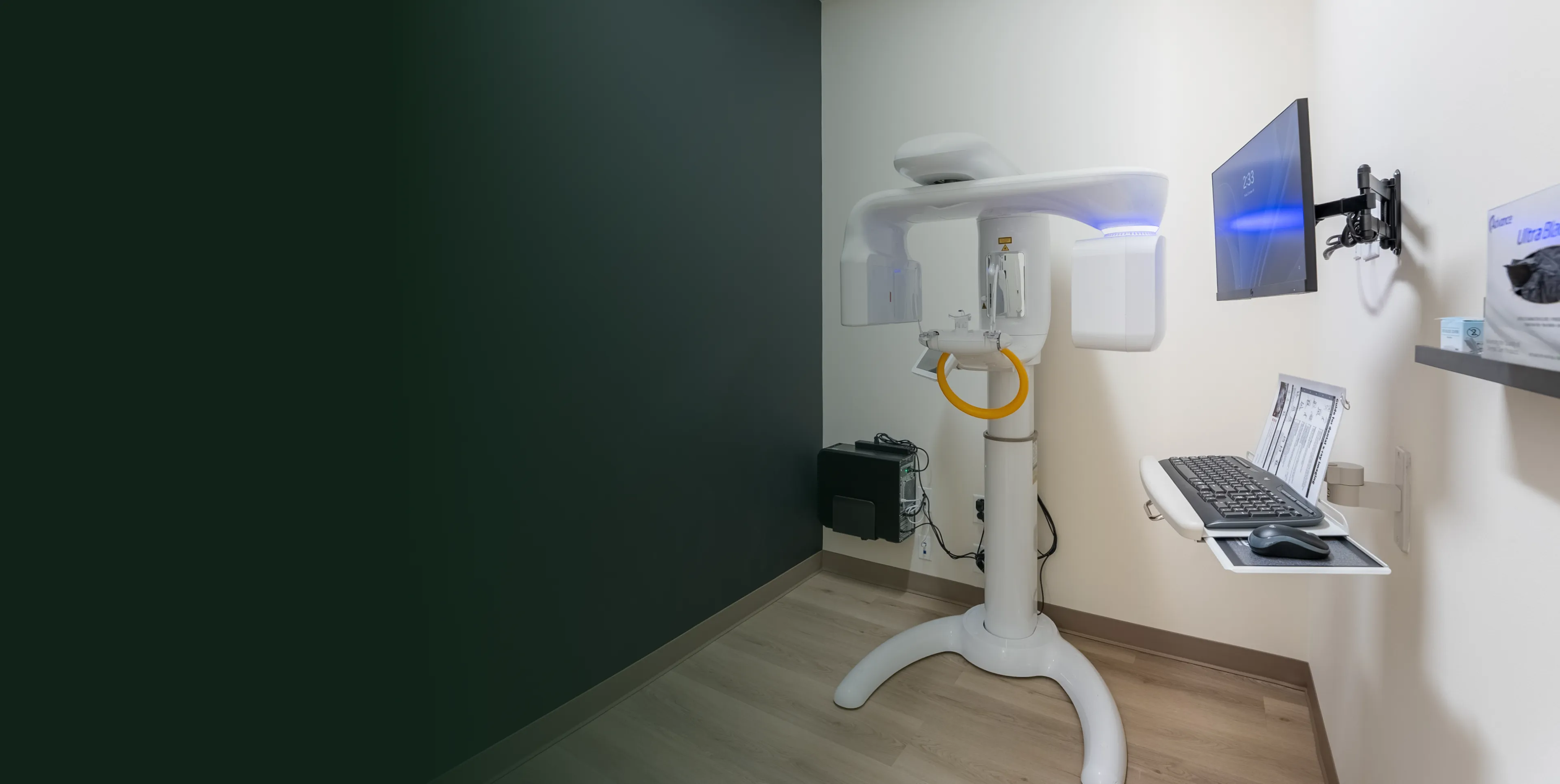 A dental imaging machine is set up in a room, ready for patient use.
