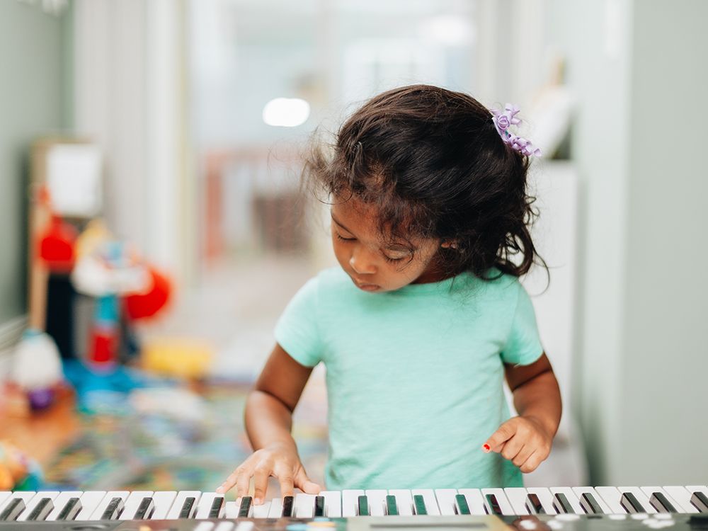 Girl playing piano at Young Leaders Academy in Brussels