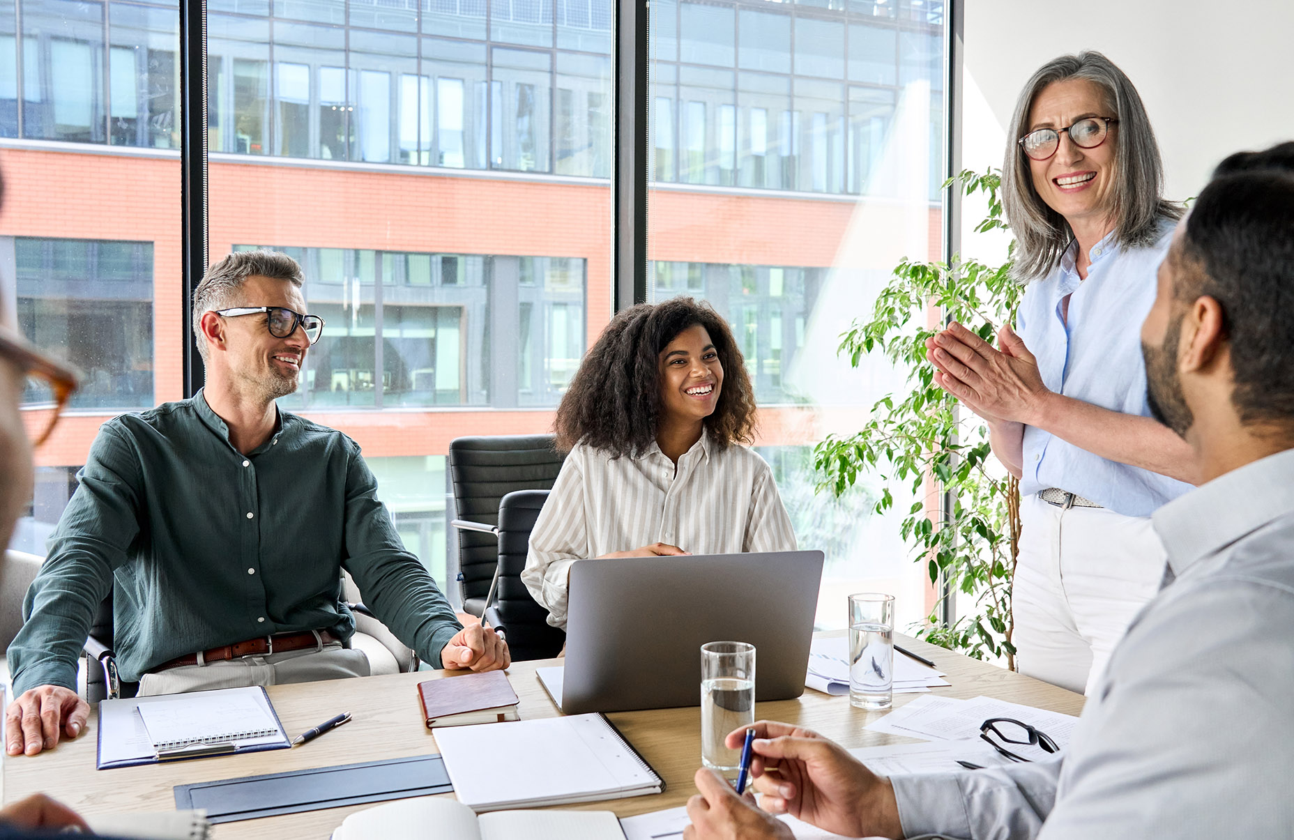 Business owner leads meeting with her employees as she plans her transition out of the company