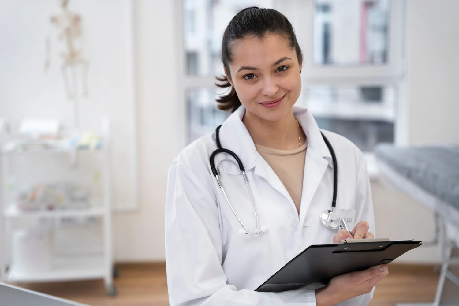 Doctor in the hospital smiling and holding some type of form